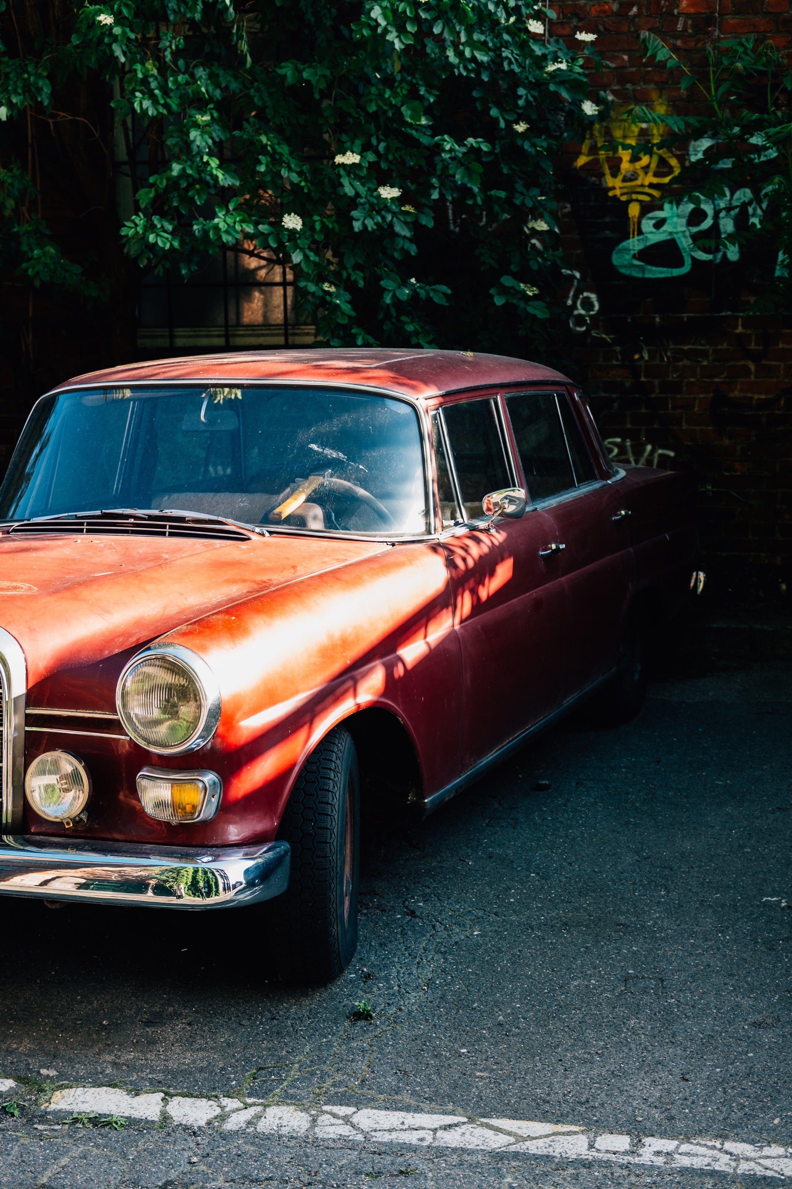 files/red-vintage-car-parked-by-brick-wall.jpg